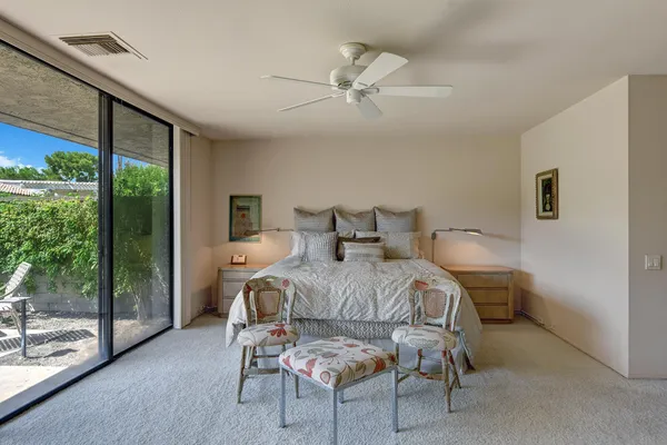 a bedroom with a bed and large window