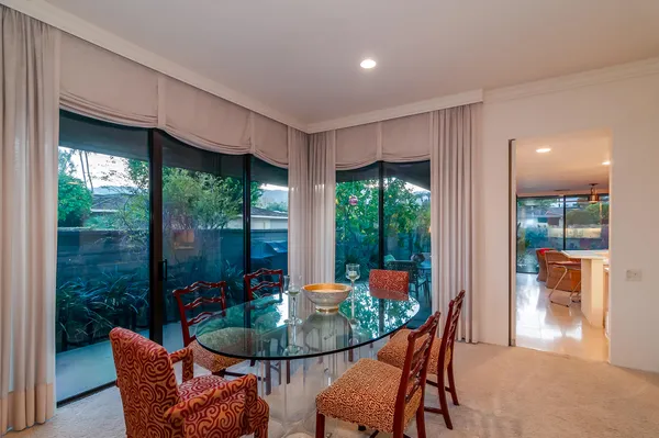 a dining room with furniture wooden floor and a potted plant
