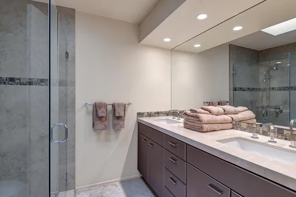 a bathroom with a double vanity sink and mirror