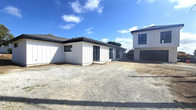 a view of garage yard and deck