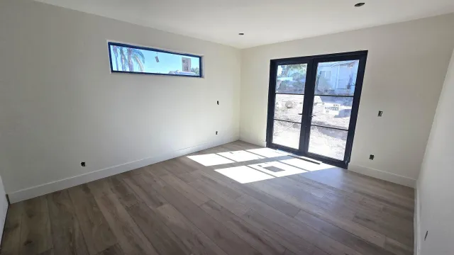 a view of wooden floor and windows in an empty room