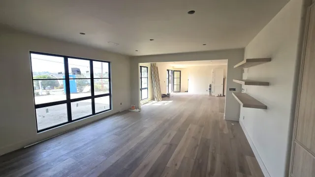 wooden floor in an empty room with a window