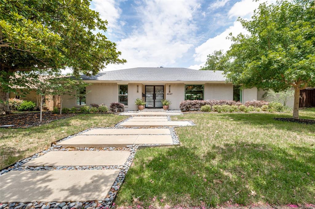 Single story home featuring a front yard, french doors, and stucco siding