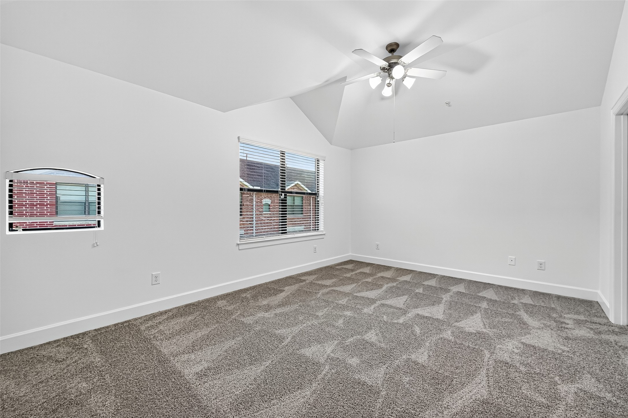 2710 Hullsmith Drive, Unit 1303 Houston, TX 77063 - Photo 17 of 25 an empty room with chandelier fan and windows