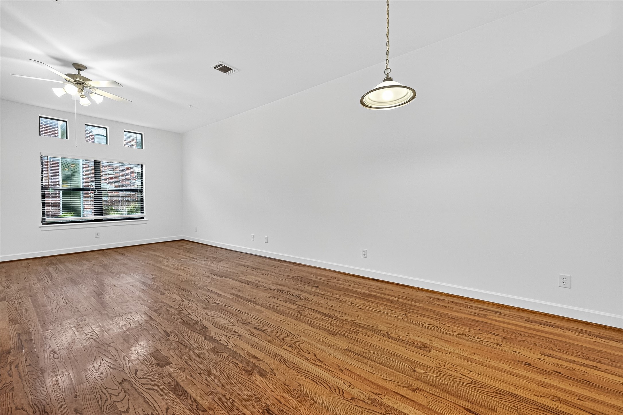 2710 Hullsmith Drive, Unit 1303 Houston, TX 77063 - Photo 5 of 25 a view of a room with wooden floor and fan