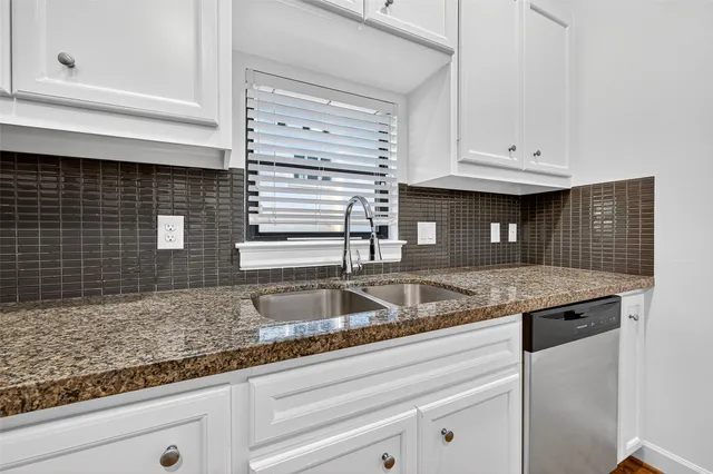 a stove top oven sitting inside of a kitchen