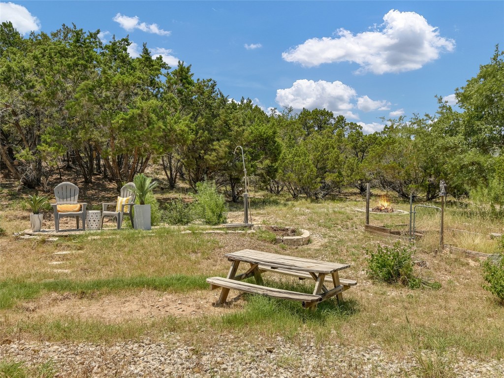 18304 West Reed Park Road Jonestown, TX 78645 - Photo 20 of 24 A rustic outdoor retreat features an open clearing nestled against mature trees.