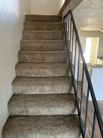 a view of staircase with white walls