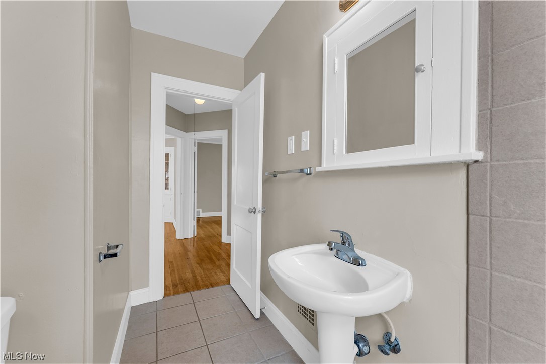 3609 Strandhill Road Shaker Heights, OH 44122 - Photo 9 of 47 Bathroom with toilet, tile walls, and tile floors