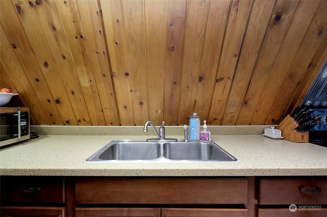 a view of a patio with a table and chairs under an umbrella