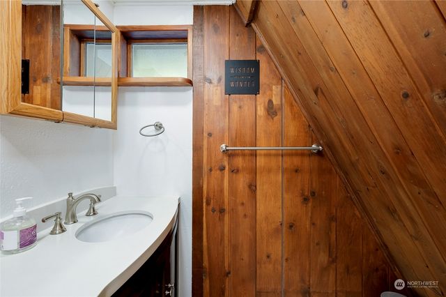 a bathroom with a sink and mirror