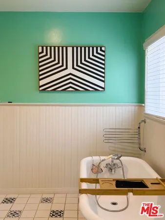 a bedroom with a bed lamp and a dresser