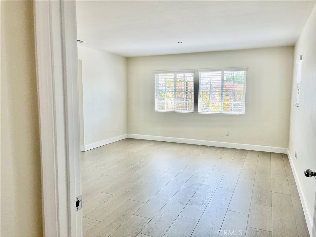 736 Tangelo Way Fullerton, CA 92832 - Photo 14 of 36 an empty room with wooden floor and windows