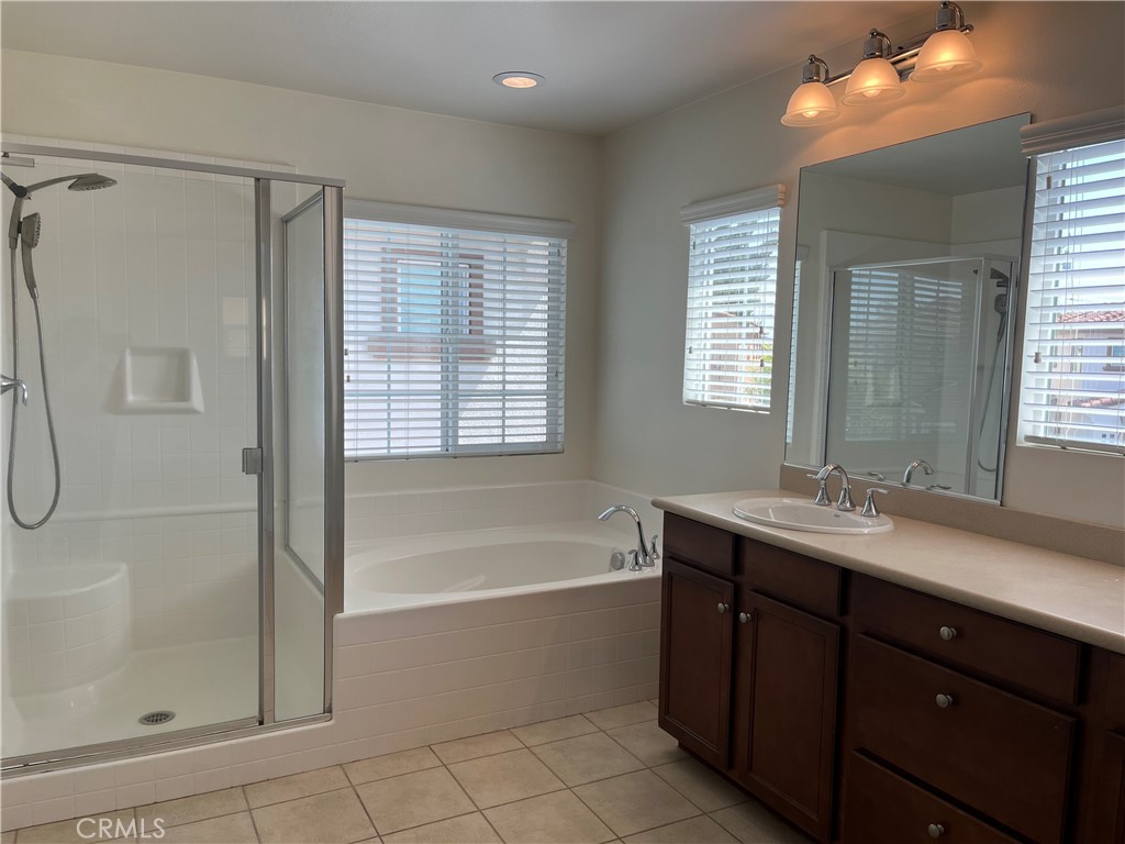 736 Tangelo Way Fullerton, CA 92832 - Photo 20 of 36 a bathroom with a tub sink shower and mirror