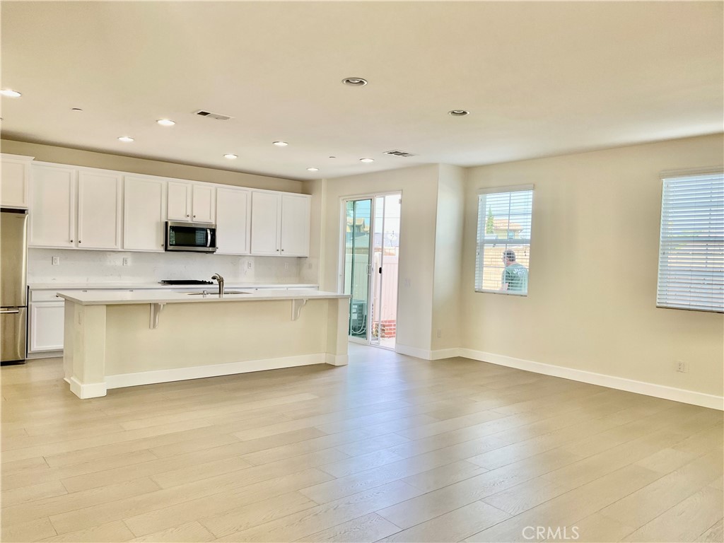 736 Tangelo Way Fullerton, CA 92832 - Photo 2 of 36 a large kitchen with stainless steel appliances granite countertop a stove a sink a refrigerator and white cabinets with wooden floor