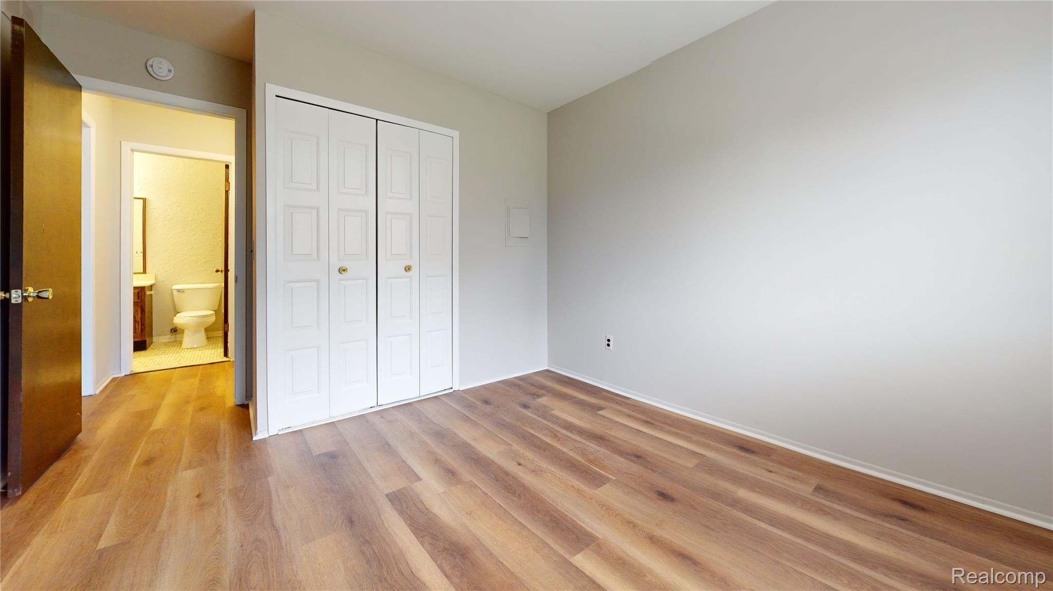 29125 Hayes Road Warren, MI 48088 - Photo 10 of 12 Wood-finish flooring throughout, bright white walls, and a convenient bi-fold closet