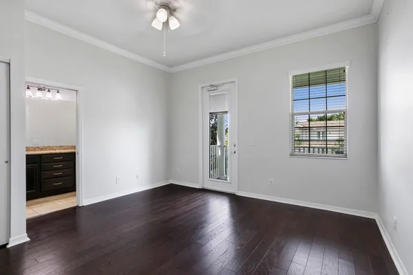 a view of a livingroom with wooden floor and a ceiling fan