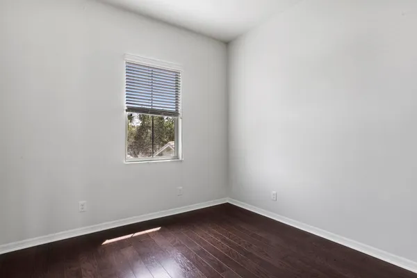 an empty room with wooden floor and closet