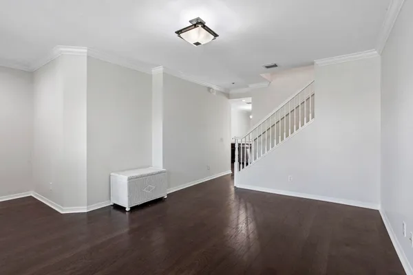 a view of an empty room with wooden floor