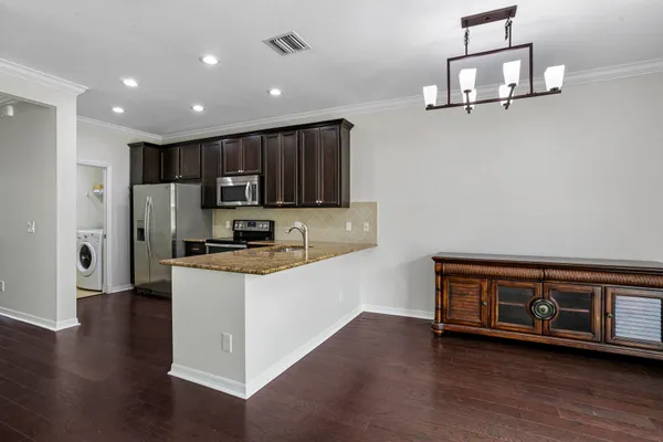 a kitchen with granite countertop stainless steel appliances and wooden cabinets