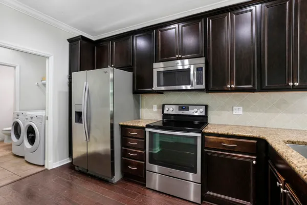 a view of a room with wooden floor and a ceiling fan