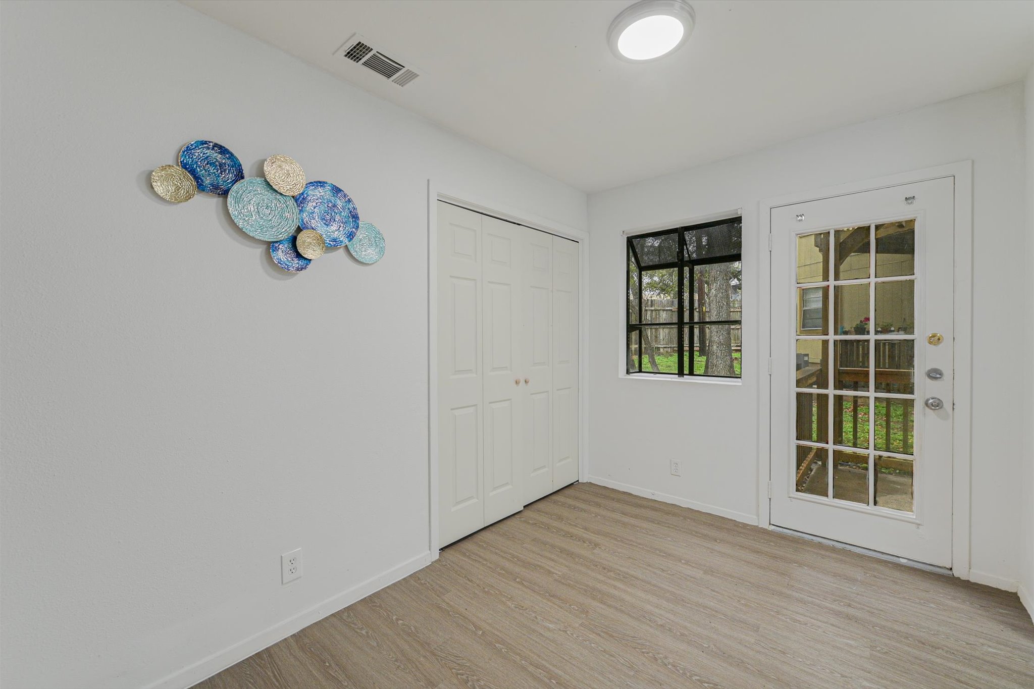 4301 Acropolis Court, Unit B Austin, TX 78759 - Photo 4 of 10 Unfurnished bedroom featuring light wood finished floors and a closet