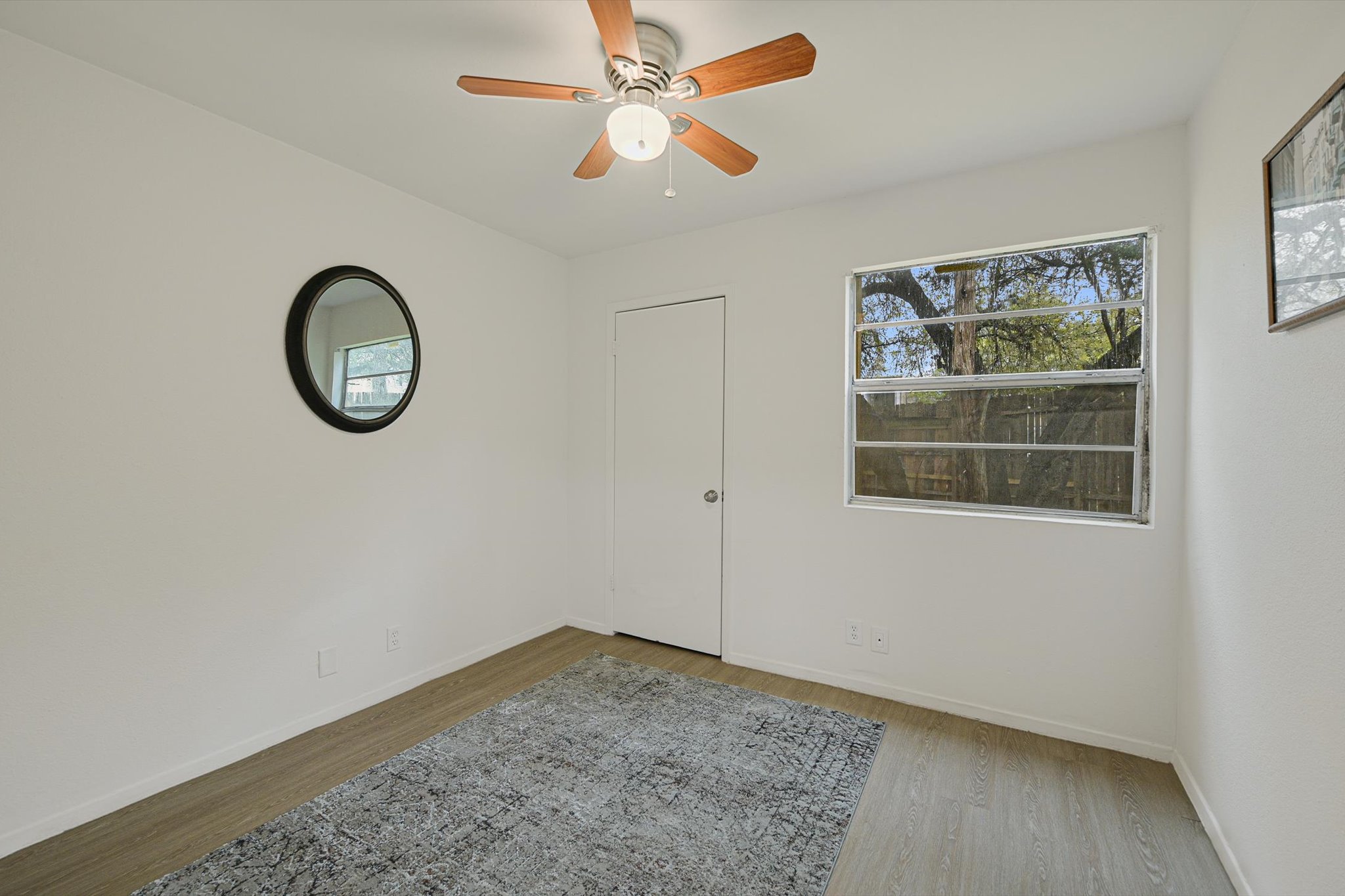 4301 Acropolis Court, Unit B Austin, TX 78759 - Photo 6 of 10 Empty room featuring light wood-style flooring and ceiling fan