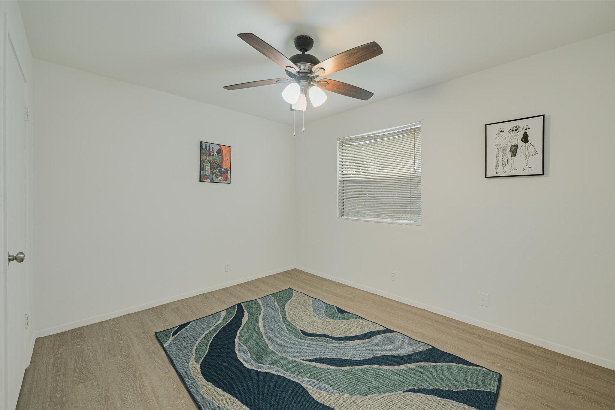 4301 Acropolis Court, Unit B Austin, TX 78759 - Photo 8 of 10 Empty room with light wood-type flooring and a ceiling fan