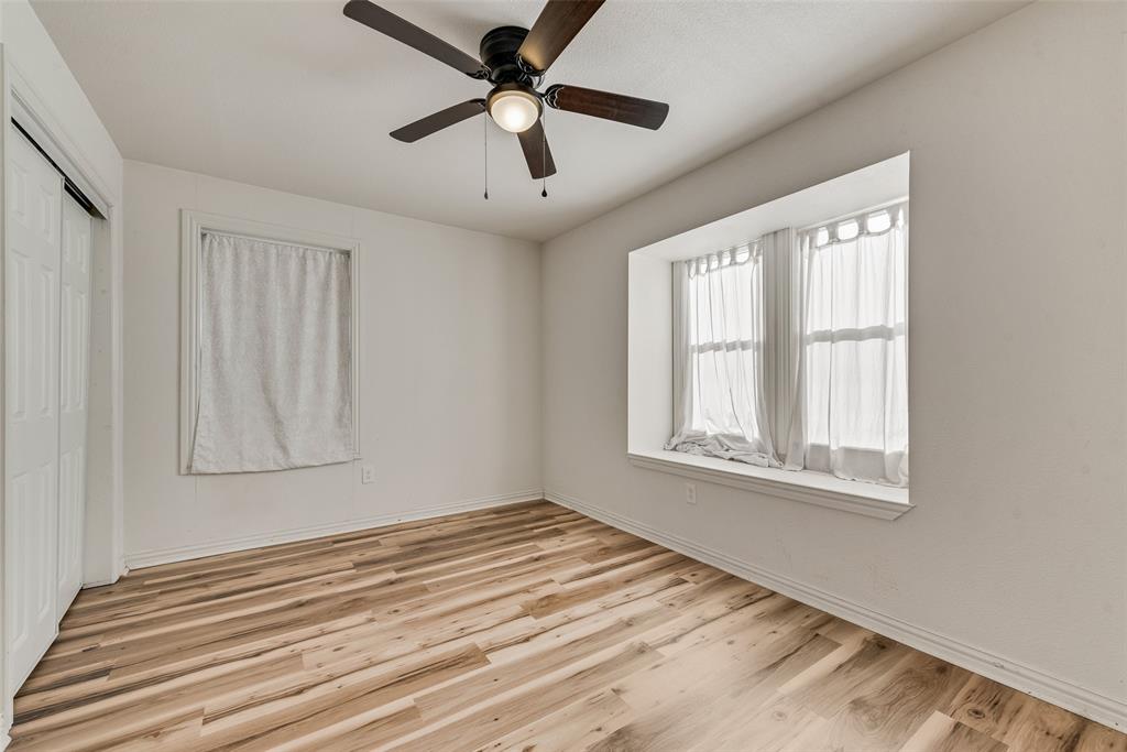 1303 South Medora Street Terrell, TX 75160 - Photo 11 of 12 a view of empty room with wooden floor and fan