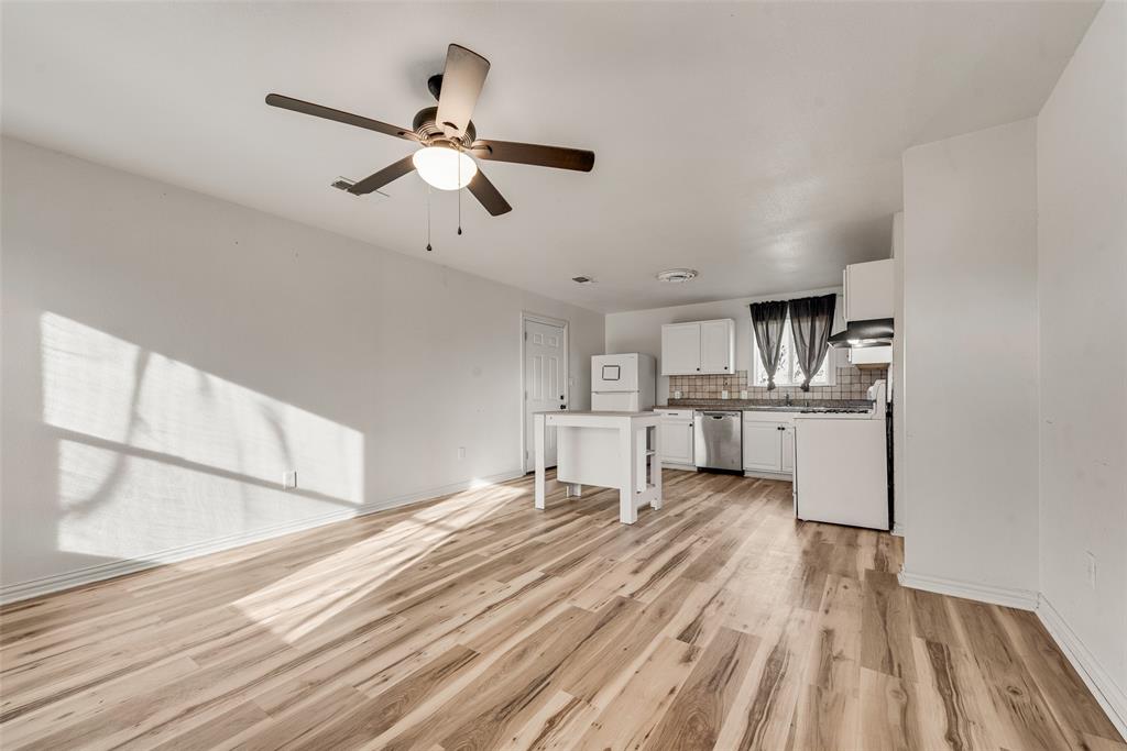1303 South Medora Street Terrell, TX 75160 - Photo 2 of 12 a living room with stainless steel appliances furniture and a kitchen view