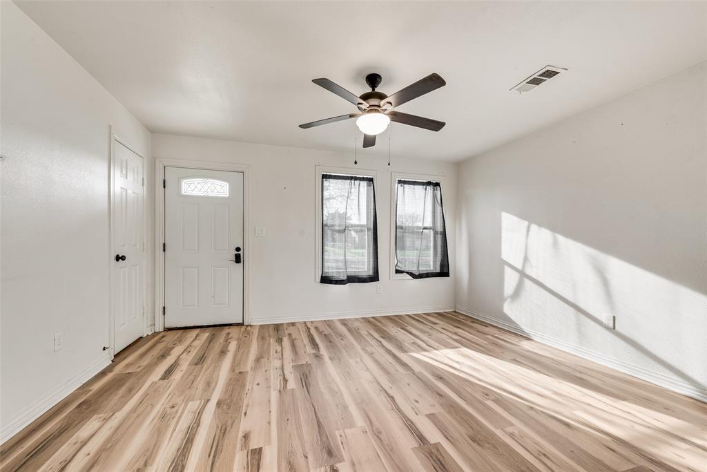 1303 South Medora Street Terrell, TX 75160 - Photo 7 of 12 a view of empty room with wooden floor and fan
