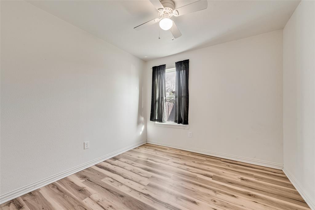 1303 South Medora Street Terrell, TX 75160 - Photo 10 of 12 a view of an empty room with wooden floor and a window