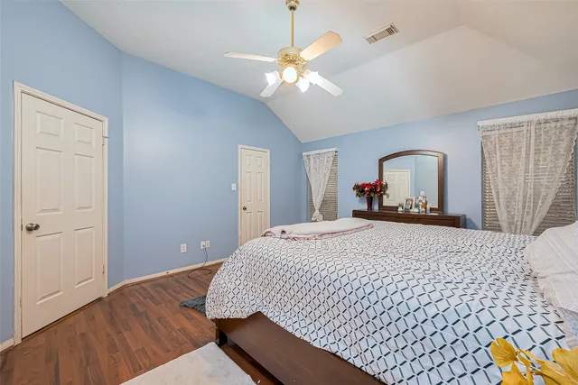 a spacious bathroom with a granite countertop sink a mirror and a bathtub
