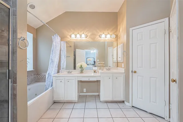 a bathroom with a tub shower and sink