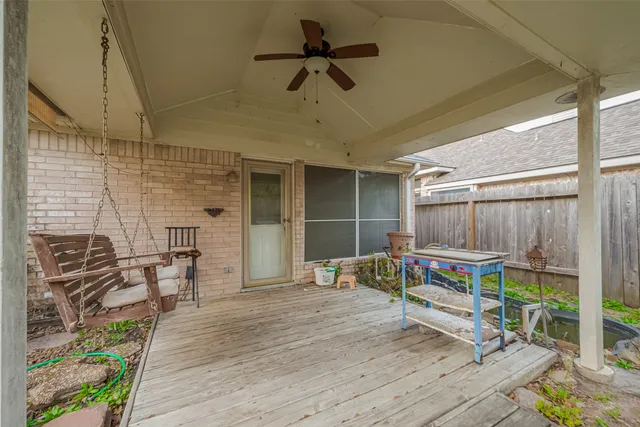 a backyard of a house with wooden floor a yard and outdoor seating