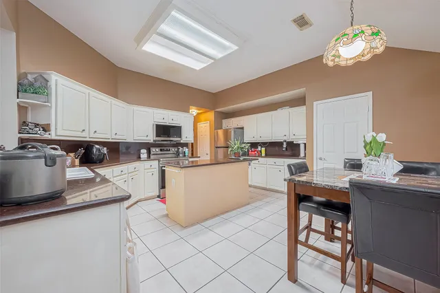 a view of a dining room with furniture and chandelier