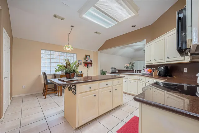 a kitchen with stainless steel appliances granite countertop a sink and a refrigerator