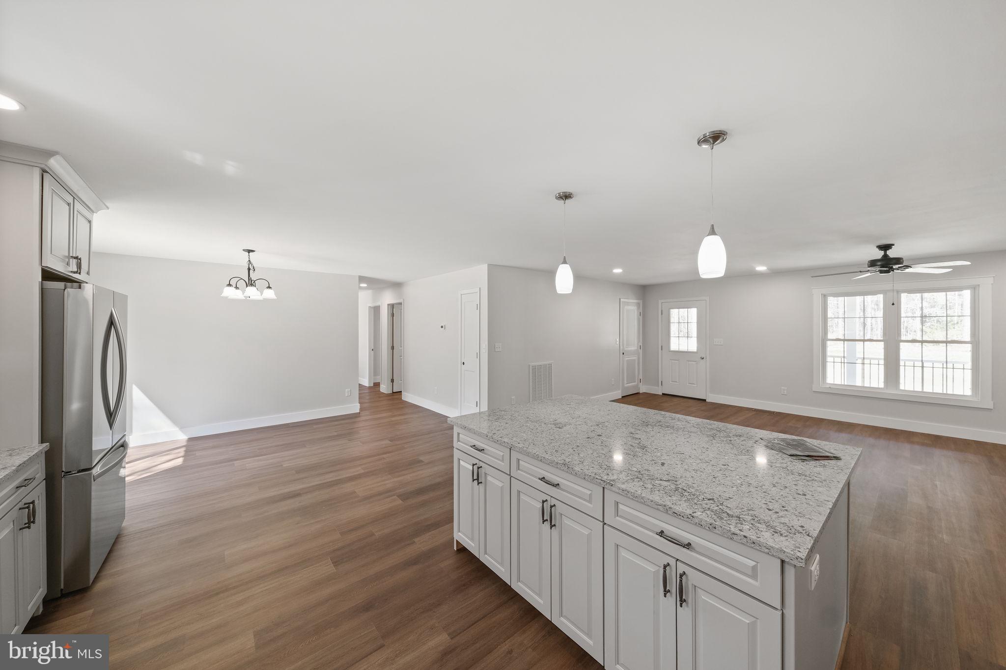 646 Sandy Point Road Heathsville, VA 22473 - Photo 11 of 39 a kitchen with granite countertop a sink and a refrigerator