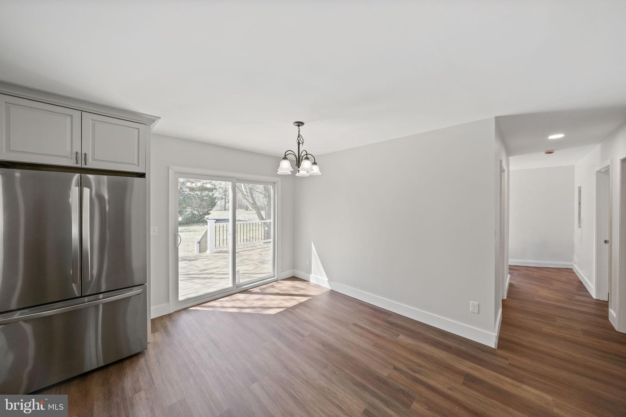 646 Sandy Point Road Heathsville, VA 22473 - Photo 13 of 39 a view of a kitchen with wooden floor and a refrigerator