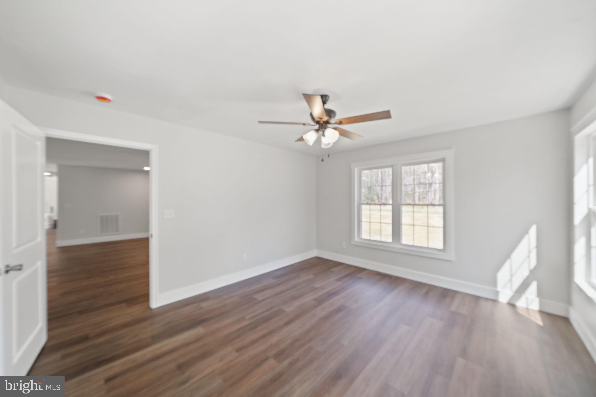 646 Sandy Point Road Heathsville, VA 22473 - Photo 15 of 39 a view of an empty room with wooden floor and a window