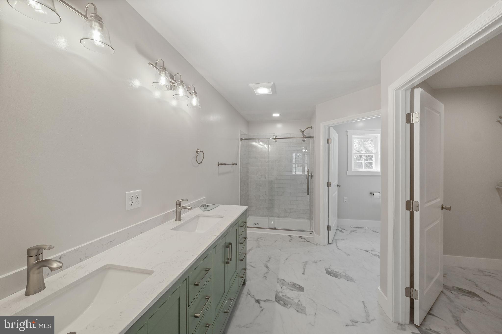 646 Sandy Point Road Heathsville, VA 22473 - Photo 21 of 39 a bathroom with a sink shower and a mirror