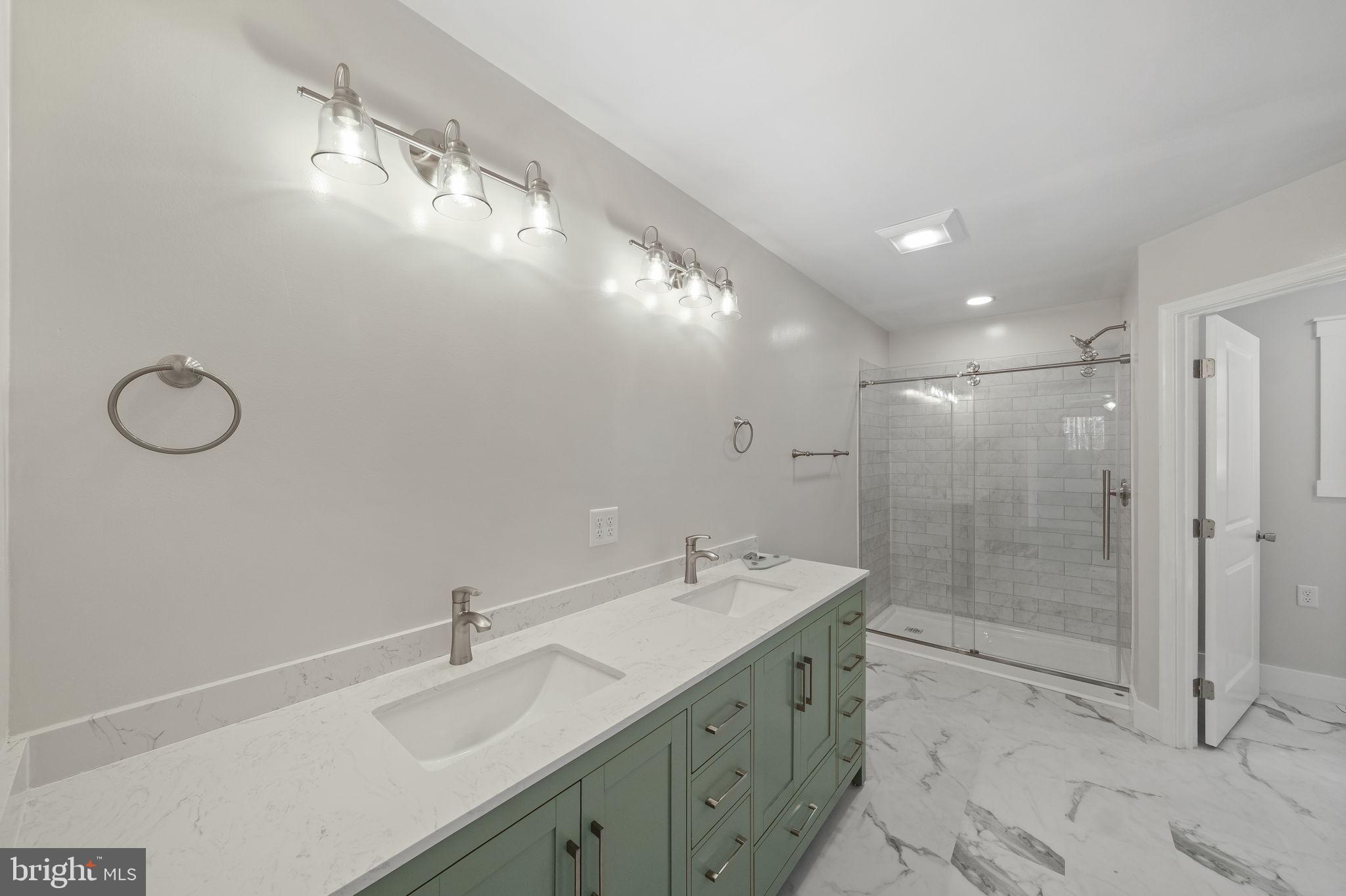 646 Sandy Point Road Heathsville, VA 22473 - Photo 22 of 39 a bathroom with a sink mirror and shower