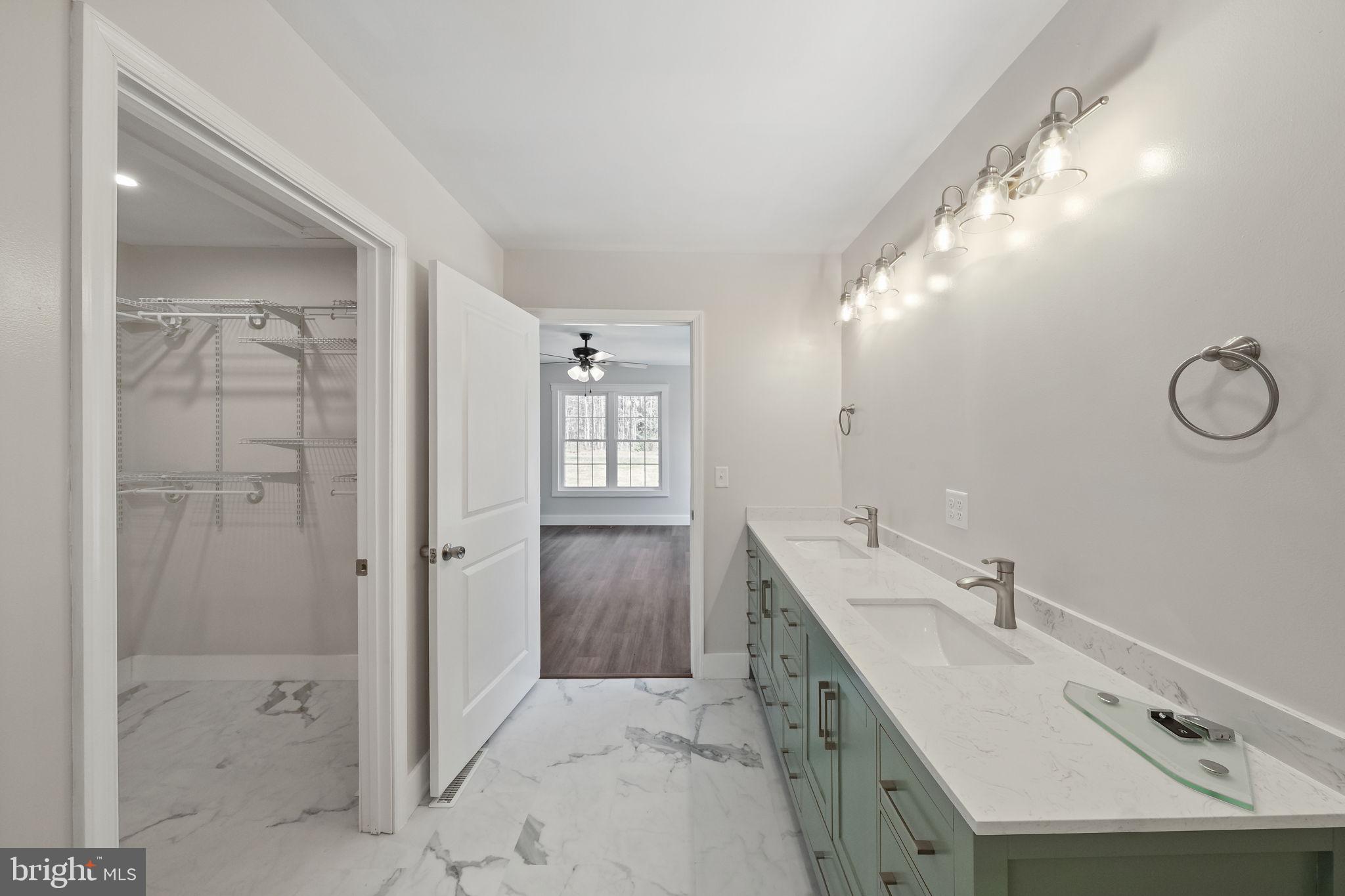646 Sandy Point Road Heathsville, VA 22473 - Photo 25 of 39 a bathroom with a double vanity sink mirror and shower