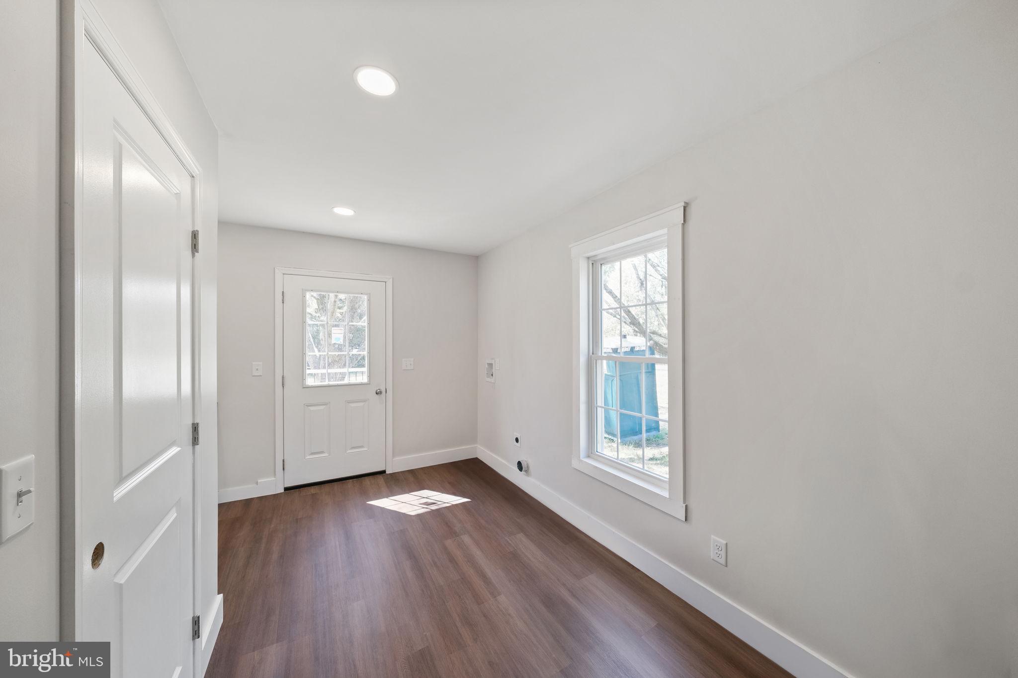 646 Sandy Point Road Heathsville, VA 22473 - Photo 28 of 39 a view of an empty room with wooden floor and a window