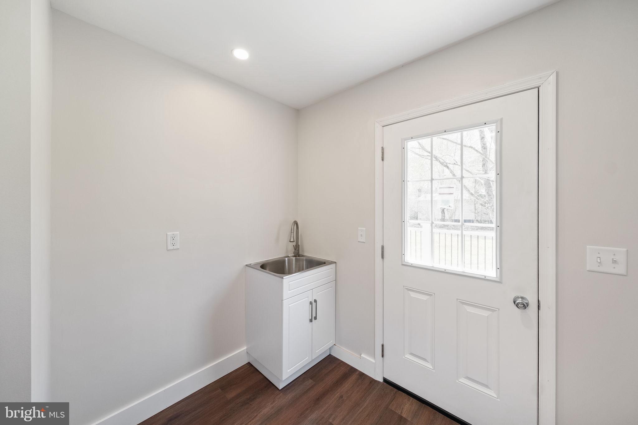 646 Sandy Point Road Heathsville, VA 22473 - Photo 29 of 39 a view of an empty room with wooden floor and a window
