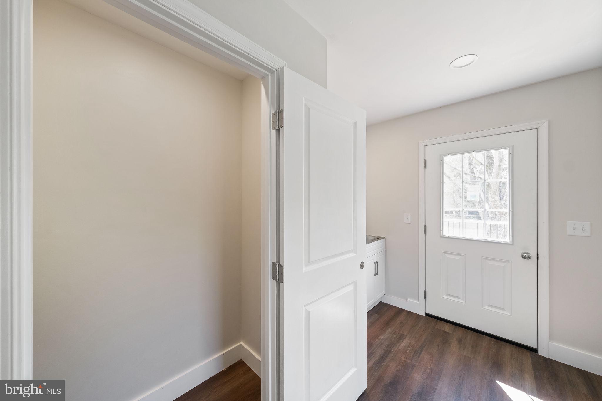 646 Sandy Point Road Heathsville, VA 22473 - Photo 33 of 39 a view of an empty room with wooden floor and a window