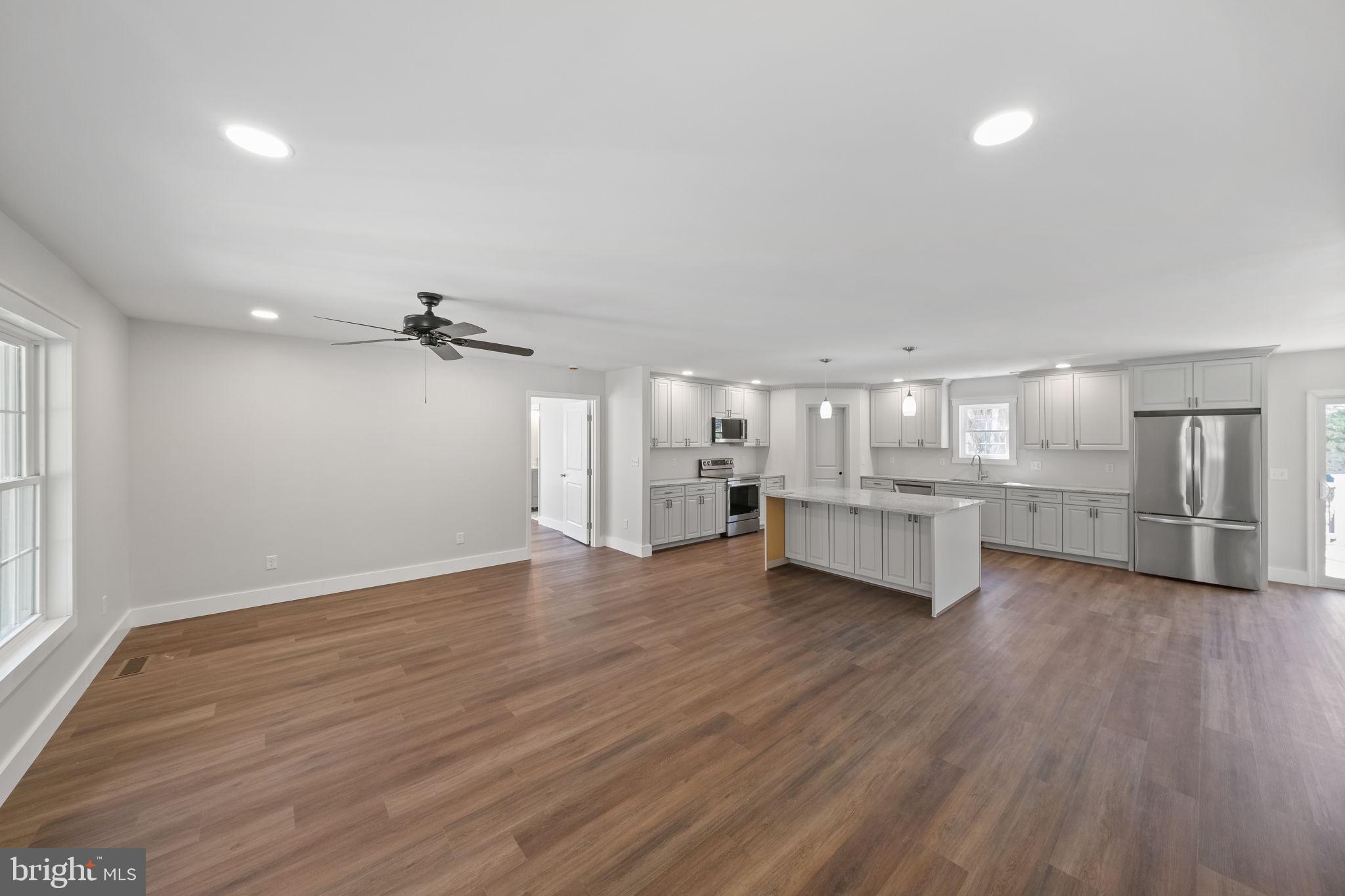 646 Sandy Point Road Heathsville, VA 22473 - Photo 35 of 39 a view of a kitchen with furniture and wooden floor