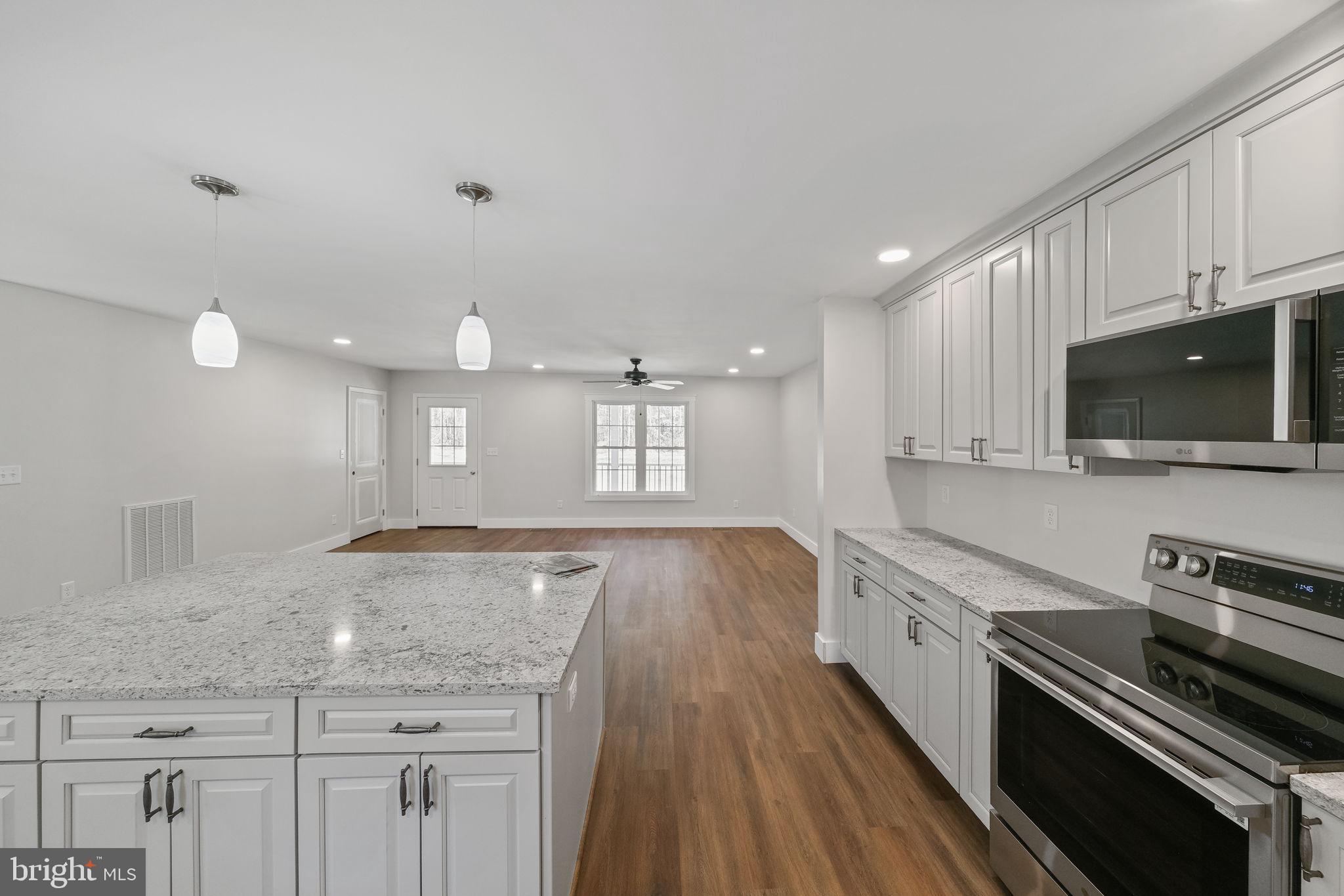 646 Sandy Point Road Heathsville, VA 22473 - Photo 38 of 39 a kitchen with a sink stove top oven and microwave