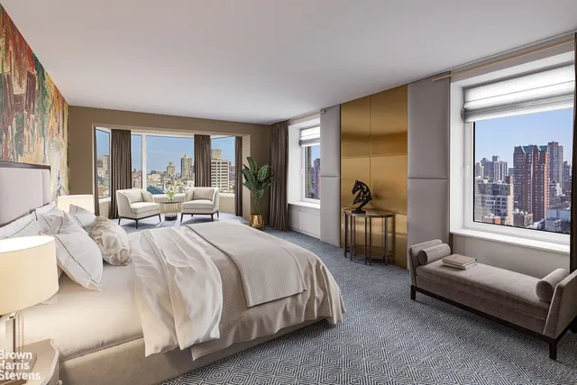 a spacious bedroom with a bed couch and a large window