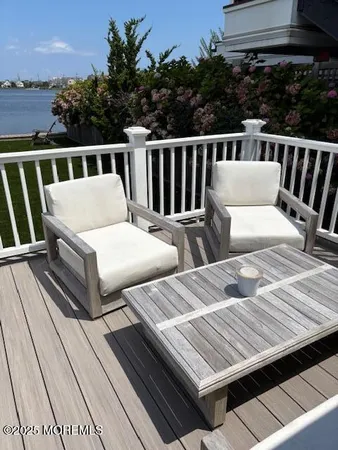 a view of balcony with wooden floor and seating space